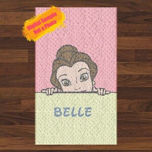 May include: A pink and yellow rug featuring a cartoon image of Belle from Beauty and the Beast. The rug has a textured surface and the words "Belle" are printed on the bottom.