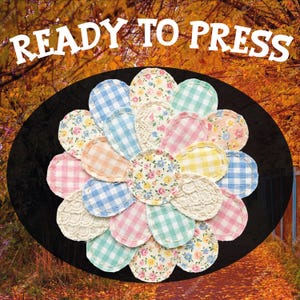 May include: A collection of fabric circles in various patterns and colors, arranged in a flower-like design. The circles feature gingham, floral, and lace details. The text "READY TO PRESS" is displayed above the design.