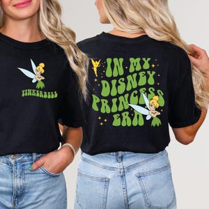May include: Black t-shirt with a green and yellow graphic print of Tinkerbell and the text "In My Disney Princess Era".