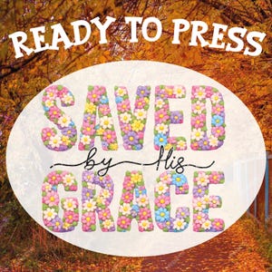 May include: A design with the words "READY TO PRESS" at the top. The words "SAVED by His GRACE" are in a floral design, with each letter filled with colorful flowers. The background is a blurred image of fall foliage.