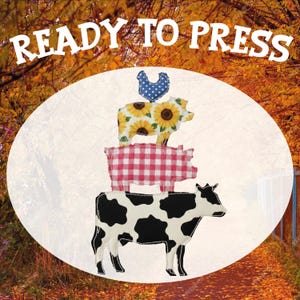 Peut inclure: Un motif fantaisiste représentant une vache, un cochon et une poule empilés les uns sur les autres. Le cochon a un motif à carreaux rouges et blancs, le cochon du milieu est décoré de tournesols et la poule est bleue à pois blancs. Les mots "READY TO PRESS" sont en haut.