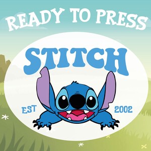May include: A blue cartoon character, Stitch, with large eyes and ears, is centered on a white oval. The word "STITCH" is above the character in blue letters. The text "READY TO PRESS" is above the oval. The text "EST 2002" is below the character.