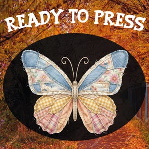 May include: A patchwork butterfly design with blue, pink, and yellow fabric wings, set against a black oval. The text "READY TO PRESS" is arched above the butterfly. The background features an autumn scene with a path and trees.