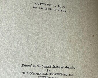 May include: A close-up of a cream-colored book page with printed text. The text reads "COPYRIGHT, 1913 BY LUTHER H. CARY" and "Printed in the United States of America by THE COMMERCIAL BOOKBINDING CO. CLEVELAND, O."