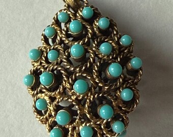 May include: A teardrop-shaped pendant crafted from gold-toned metal featuring a textured, twisted wire design. The surface is adorned with numerous small, round, bright turquoise-colored beads set within the center of each twisted wire loop.