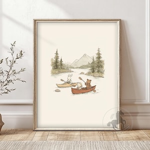 May include: A framed illustration depicts three cartoon animals canoeing on a river. A rabbit and a small bear paddle in separate canoes. The background features trees, mountains, and a light-colored sky. The artwork is framed in a gold-colored frame.