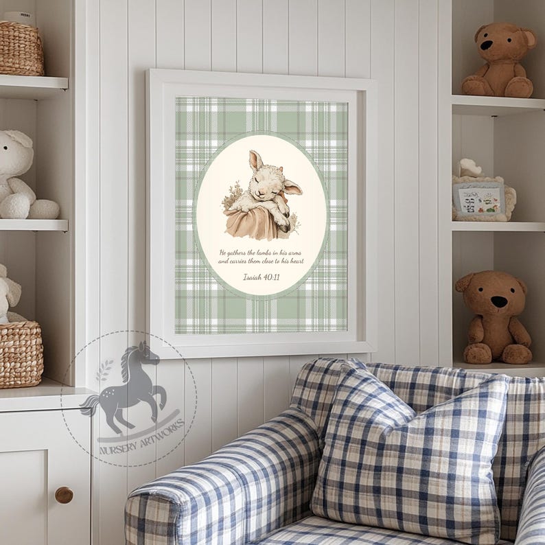 May include: A framed print featuring a sleeping lamb illustration within an oval, set against a green plaid background. The text reads "He gathers the lambs in his arms and carries them close to his heart Isaiah 40:11." The print is part of a nursery artwork collection.