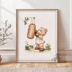 May include: A watercolor illustration of a brown teddy bear wearing boxing gloves and punching a brown punching bag. The bear is wearing a white onesie and brown shoes. The illustration is set against a white background with green foliage.