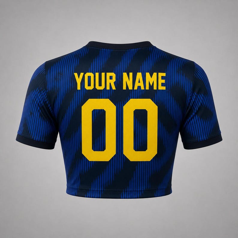 Back product mockup of a navy and blue Brazil-inspired football crop top with custom name and yellow number 00.