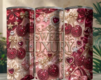 May include: A cylindrical tumbler featuring a repeating pattern of red crystal-encrusted cherries, gold bows, pearls, and heart-shaped gems on a satin-like background. The text SWEET LUXURY is printed in gold, ornate, metallic-style lettering.