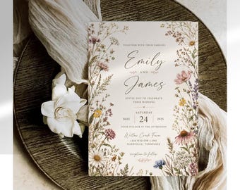 May include: A rectangular wedding invitation card featuring a cream background with a colorful wildflower border. The text reads: Together with their families, Emily and James, invite you to celebrate their wedding, Saturday, May 24, 2025, at four o'clock in the afternoon, Willow Creek Farm, 1234 Willow Lane, Nashville, Tennessee, reception to follow.