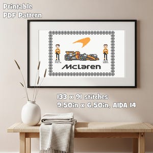 May include: A framed cross-stitch pattern depicting a McLaren Formula 1 car, logo, and driver figures. The pattern includes the text "McLaren", driver names, and the dimensions: 24.13cm x 16.51cm. The words "Printable PDF Pattern" are at the top.