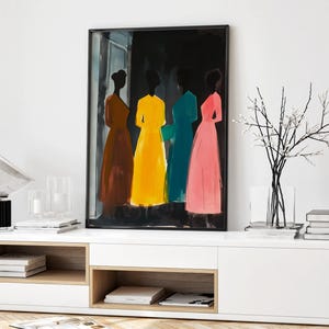 May include: A framed painting of four women in colorful dresses standing in a dark room. The women are silhouetted against a black background, and their dresses are shades of brown, yellow, teal, and pink.
