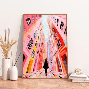 May include: A painting of a colorful city street with tall buildings and a person walking down the middle. The buildings are painted in shades of pink, orange, and yellow, and the street is a mix of pink, blue, and yellow.