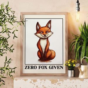 May include: Framed art print featuring a cartoon fox with orange and white fur, a smug expression, and the text "ZERO FOX GIVEN" in black. The artwork is in a wooden frame, displayed on a shelf with plants and a watering can.