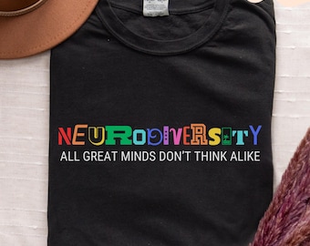 May include: Black t-shirt with a rainbow colored graphic that says "Neurodiversity" and "All great minds don't think alike".