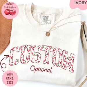 Make it yours with this Custom Comfort Colors Cherry Shirt, featuring fully customizable text—add a name, or a meaningful phrase, with an optional second line for extra personalization. 🍒 Designed with a vibrant cherry pattern, this fun and playful print adds a sweet, vintage-inspired touch to your personalized tee. 🎁 Perfect for gifting, whether you're celebrating a retro fashion lover, a cheerful personality, or someone who adores unique designs, this shirt is a charming and standout choice.