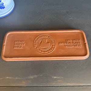 May include: A white ceramic mug with a black handle and the text "But First, Coffee" in a bold, black font. The mug sits on a white surface, showcasing its clean design.