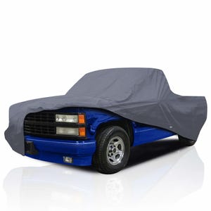 May include: A gray car cover draped over a blue pickup truck. The cover is made of a durable material and protects the vehicle from the elements. The truck has a black grill and chrome wheels.