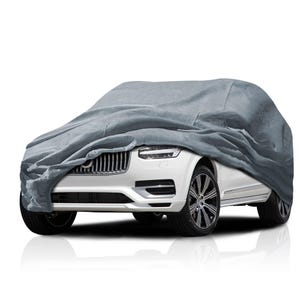May include: A gray car cover draped over a white SUV. The cover is made of a soft, textured material. The SUV has black wheels and a silver grill.