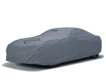 May include: A gray car cover with the logo "CASHEILD" printed on the front. The cover is designed to fit a car and is made of a durable material. The car cover is gray and protects the car from the elements.
