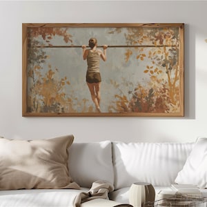 May include: A framed art print depicts a person doing a pull-up on a horizontal bar. The artwork features a muted color palette with a focus on warm tones, including browns and oranges, suggesting an outdoor setting with foliage.