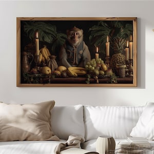 May include: A framed artwork depicts a monkey in a blue vest seated at a table laden with fruit, candles, and foliage. The painting has a dark, classical style with a wooden frame, creating a vintage aesthetic. The scene is lit by candlelight.