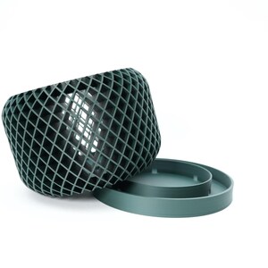 Ravik orchid pot shown on its side with removable saucer and open ventilation pattern