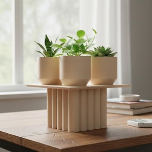 May include: A wooden plant stand with three small potted plants. The stand has a rectangular top and a base made of vertical wooden dowels. The pots are light-colored and hold various green plants. The stand is on a wooden table.
