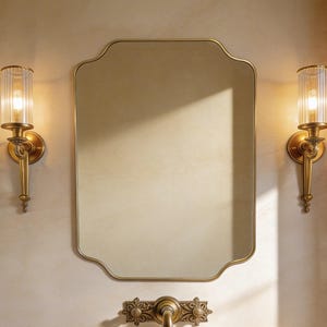 Elegant scalloped wall mirror with a thin vintage brass frame, rectangular cut corner vanity glass for luxury bathroom and bedroom decor