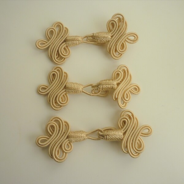 Three Decorative fasteners, beige art silk
