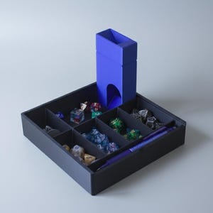 May include: A black dice tray with a blue dice tower and compartments filled with colourful polyhedral dice. A blue pen rests in the tray. The dice tower is a vibrant blue colour, and the dice are various colours and designs.