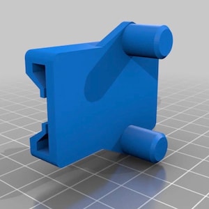 May include: A 3D-rendered, bright blue plastic component. The object has a rectangular body with two cylindrical protrusions and a notched section. The design suggests a mechanical part or connector.