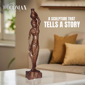 May include: A brown wooden sculpture of a woman carrying a jug on her head. The sculpture is on a square base and is set on a white table. The text on the image reads: "A SCULPTURE THAT TELLS A STORY."