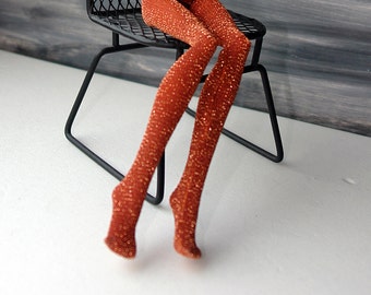May include: A pair of orange sparkly tights with a shimmery finish.