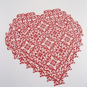 A letterpress heart printed from individual metal type &#39;arabesque&#39; fleurons onto A4 crane&#39;s Lettra cotton paper