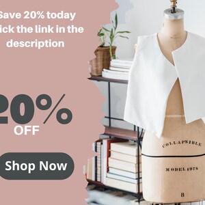 May include: A pink and white graphic with the text "Save 20% today Click the link in the description" and "20% OFF" in large black text. A button with the text "Shop Now" is below the text. A white sleeveless garment is displayed on a mannequin in the background.