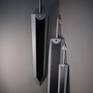 May include: Three large, heavy-duty swords of varying sizes displayed in a corner. Each sword features a wide, flat black blade with silver-colored edges, a circular silver guard, and a long cylindrical handle. The handles have light-colored fabric wraps.