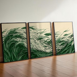 Peut inclure: Trois impressions d'art encadrées appuyées contre un mur. Chaque impression présente une illustration stylisée d'herbe verte soufflant dans le vent sur un fond crème. Les cadres sont noirs.