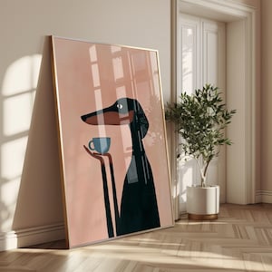 May include: A framed wall art print featuring a stylized black and brown dog with a long snout, holding a small light blue cup in its paws. The background is a solid soft peach color, and the artwork is encased in a thin metallic frame.