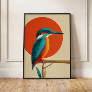 Peut inclure: Impression d'art encadrée représentant un martin-pêcheur stylisé perché sur une branche. L'oiseau a un plumage bleu sarcelle, orange et blanc, sur un fond crème avec un grand cercle orange. L'œuvre est dans un cadre noir.