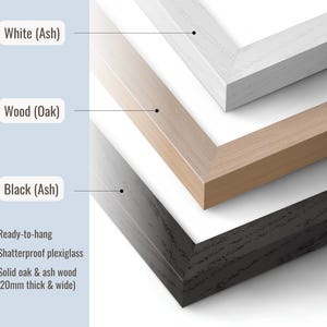 May include: Three rectangular picture frames stacked diagonally, featuring white ash, natural oak, and black ash wood finishes. Each frame includes shatterproof plexiglass and measures 20mm thick and wide. The frames are ready-to-hang.
