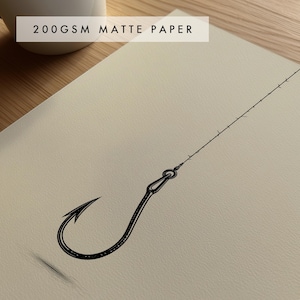 May include: A black ink line drawing of a single fishing hook attached to a thin line, printed on off-white 200gsm matte paper. The hook features a sharp barb and a looped eyelet, with the fishing line extending diagonally across the textured surface.