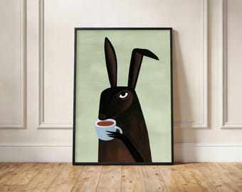 May include: A framed wall art print featuring a dark brown hare with long ears holding a light blue mug filled with a dark brown beverage. The hare is set against a solid light sage green background, and the artwork is enclosed in a thin black frame.
