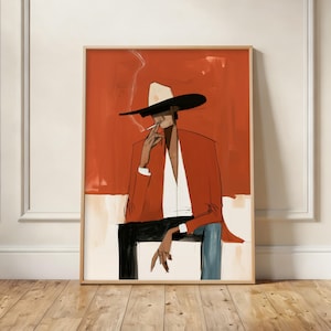 May include: A framed art print featuring a stylised illustration of a figure wearing a wide-brimmed hat and a rust-coloured jacket. The figure is seated, smoking a cigarette, with one hand resting on a knee. The background is a solid rust orange.