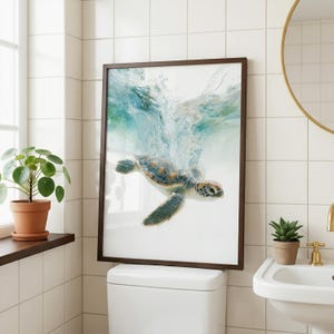 May include: A framed wall art print featuring a sea turtle swimming underwater with a splash of turquoise and white bubbles above it. The turtle has a patterned shell in shades of brown, tan, and green, with flippers extended in motion.