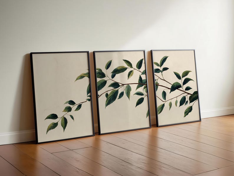 May include: A set of three rectangular wall art prints in thin black frames. Each print features a botanical illustration of a brown tree branch with dark green leaves set against a plain, light cream-colored background.