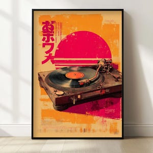 May include: Framed vintage-style poster featuring a turntable with a vinyl record. The artwork has a retro aesthetic with a red sun and Japanese text against an orange and yellow background. The poster is in a black frame.