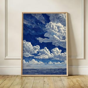 May include: A vertical rectangular framed wall art print featuring a deep blue sky filled with textured, swirling white clouds above a dark blue sea. The artwork uses thick, visible brushstrokes to create a dynamic, layered effect across the entire composition.
