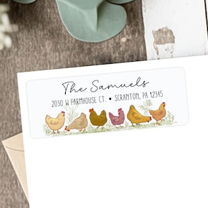 May include: White rectangular address label with the text "The Samuels" in cursive. Below, the address is printed in a smaller font. A row of cartoon chickens in various colors are at the bottom of the label.